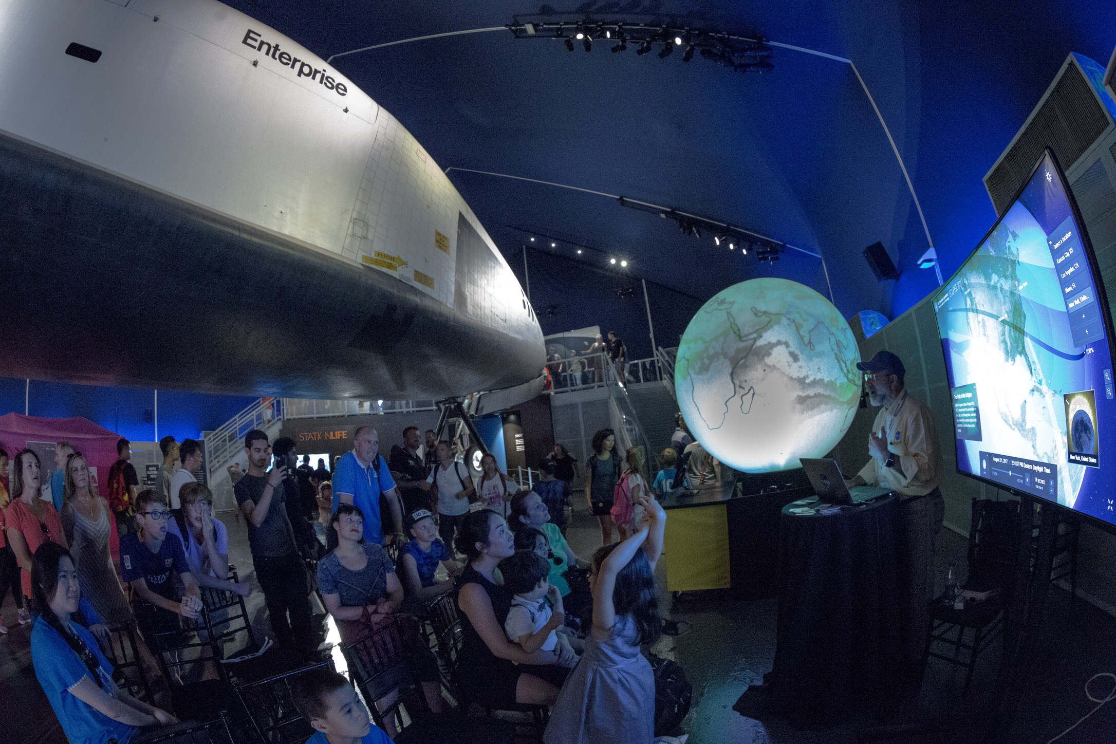 Kevin Hussey presenting eyes under NASA Shuttle enterprise